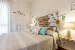 a bedroom with a bed and a brick wall at ClickSardegna Villa Emanuel spectacular sea view, with independent swimming pool in Alghero +76 photos