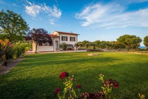 a large yard with a house in the background at ClickSardegna Villa Emanuel spectacular sea view, with independent swimming pool in Alghero