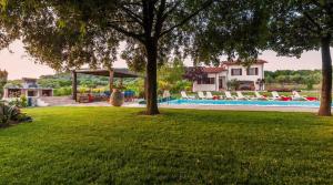 a yard with a swimming pool and a house at ClickSardegna Villa Emanuel spectacular sea view, with independent swimming pool in Alghero
