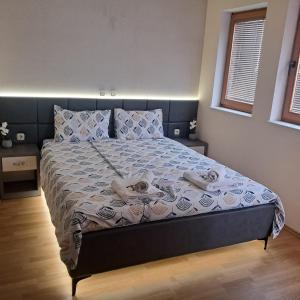 a bedroom with a bed with towels on it at Villa Rimari in Ohrid +81 photos