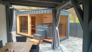a small shed with a table and a table at Domek pod Dębem in Sieniawa