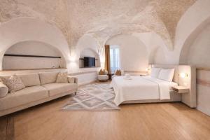 a bedroom with a bed and a couch at Muresenilor 9 Boutique - Old Town in Braşov