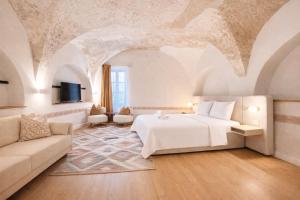 a bedroom with a bed and a couch at Muresenilor 9 Boutique - Old Town in Braşov