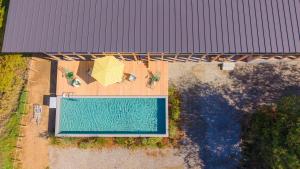 an overhead view of a swimming pool with a umbrella and chairs at KAMOME SLOW HOTEL in Awaji