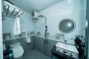 a bathroom with a toilet and a sink and a mirror at Green Homestay in Danang +9 photos