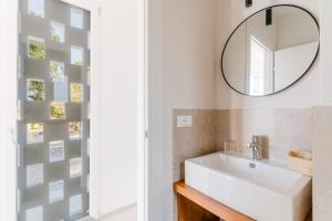 a bathroom with a sink and a mirror at Masseria Capricella in Fasano