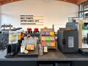 a kitchen with a counter with a coffee machine at THE GOOD ONE Hotel Landshut in Landshut