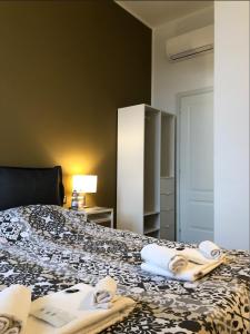 a hotel room with a bed with towels on it at Camera Albergo - Suites Mansion in Rozzano