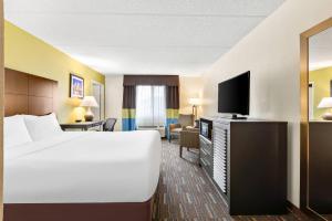 a hotel room with a bed and a flat screen tv at Comfort Inn Chula Vista San Diego South in Chula Vista