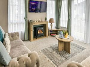 a living room with a couch and a fireplace at Seren - Uk51711 in Cockermouth