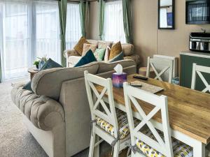 a living room with a couch and a table at Seren - Uk51711 in Cockermouth