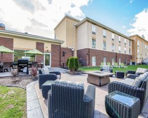 a patio with chairs and a table in front of a building at Comfort Suites Marietta-Parkersburg in Marietta