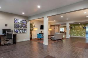 a lobby with a waiting area with a desk and chairs at Sleep Inn & Suites Kalamazoo Southwest in Kalamazoo