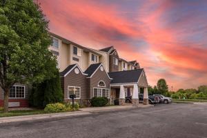 a house on a street with a cloudy sky at Sleep Inn & Suites Kalamazoo Southwest in Kalamazoo