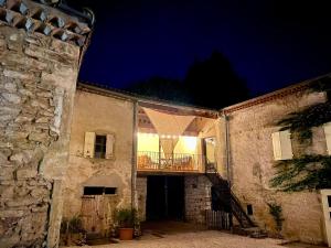 an old stone building with a balcony at night at Big Jungle in Grane