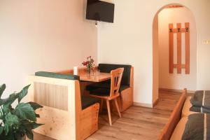 a small dining room with a table and a couch at mösslerhof in Aldino