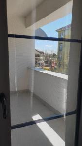 a room with a glass door with a window at Apartament in Craiova +2 photos