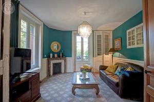 a living room with a couch and a fireplace at Le Clos des Soyeux in Saint-Victor-sur-Rhins