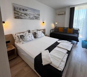 a bedroom with a large bed with white sheets and pillows at Студия 310 и 312 на първа линия in Chernomorets +37 photos