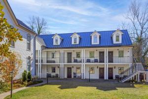 a large white house with a blue roof at The Colonial Inn, an Ascend Collection Hotel in Hillsborough