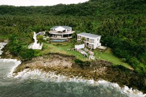 an aerial view of a house on a island in the water at Trogon's Perch in San Isidro