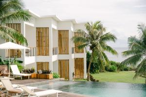 a villa with a swimming pool and palm trees at Trogon's Perch in San Isidro