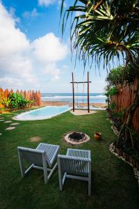 two white benches sitting in a yard with a swing at Bubble 1 - Romantic Private Pool Love Dome Uluwatu in Uluwatu
