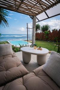 a patio with a table and a view of the ocean at Bubble 1 - Romantic Private Pool Love Dome Uluwatu in Uluwatu