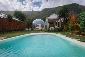 a swimming pool in a backyard with a dom building at Bubble 1 - Romantic Private Pool Love Dome Uluwatu in Uluwatu