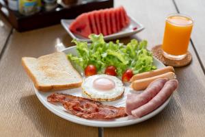 a plate of breakfast food with eggs bacon and toast at Grood Glamping in Ban Khok Sung +290 photos