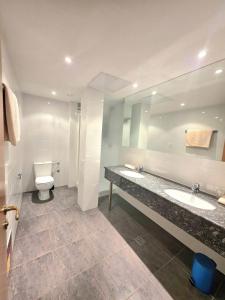 a bathroom with a sink and a toilet and a mirror at Hotel Pause - Free WiFi & Free Parking!! in Hofheim am Taunus +32 photos