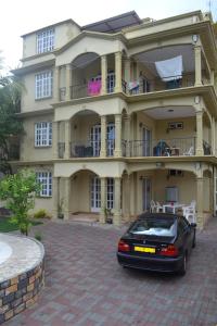 a car parked in front of a large house at RS VILLA private apartment with pool and free wifi in Flic-en-Flac