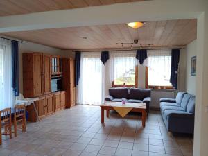 a living room with a couch and a table at Haus am Limes in Pfedelbach