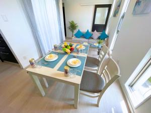 a table with fruit on it in a living room at White Cube Yagaji 沖縄 - Kouri Churaumi - 1min Beach-Max 10ppl-2 Parking in Nago