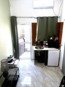 a small kitchen with a sink and a window at Cocon lumineux tout équipé in Dzaoudzi