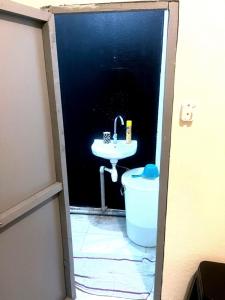 a bathroom with a sink and a toilet at Cocon lumineux tout équipé in Dzaoudzi