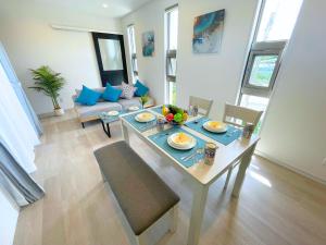 a living room with a table with food on it at White Cube Yagaji 沖縄 - Kouri Churaumi - 1min Beach-Max 10ppl-2 Parking in Nago