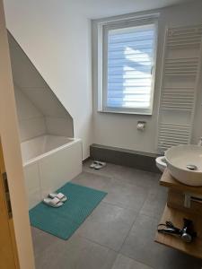 a bathroom with a sink and a toilet and a sink at Ferienwohnung in Kassel mit zwei Schlafzimmer in Kassel +12 photos