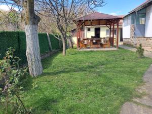 a backyard of a house with a gazebo at Miris prirode in Vrdnik