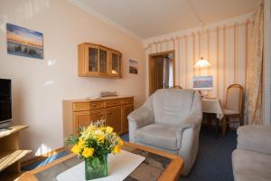 a living room with a couch and a chair at Kim im Haus Wega in Westerland