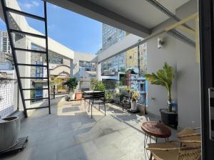 a balcony with chairs and tables in a building at Fair Dinkum Stay District 1 in Ho Chi Minh City