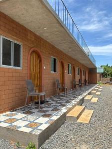 a building with chairs sitting on a tiled floor at Auro Waves Rooms & Hostel in Auroville