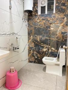 a bathroom with a toilet and a sink at Hotel PR Royal in Bhīmavaram