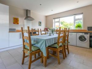a kitchen and dining room with a table and chairs at Riverside in Stone