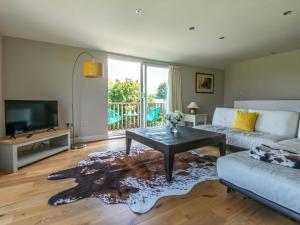 a living room with a couch and a table at Riverside in Stone