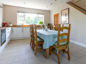 a kitchen and dining room with a table and chairs at Riverside in Stone +18 photos