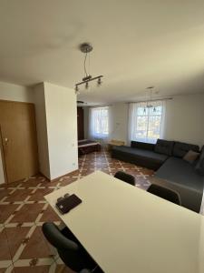 a living room with a table and a couch at Vievis Hotel Vievija in Vievis +3 photos