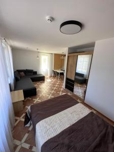 a bedroom with two beds and a table in it at Vievis Hotel Vievija in Vievis