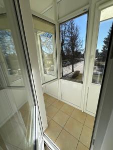 a room with two windows and a tiled floor at Vievis Hotel Vievija in Vievis