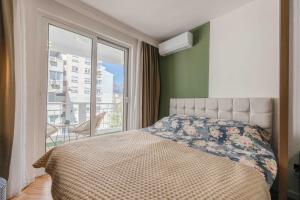 a bedroom with a bed and a large window at Stella Andrea Luxury Apartment in Bar